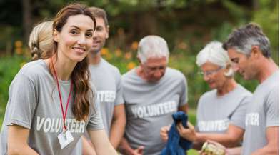 Happy volunteer looking at donation box