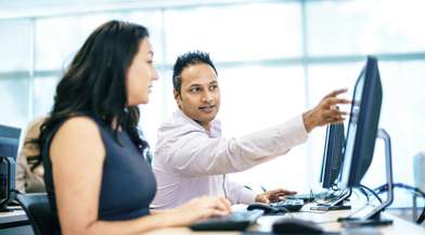 Two workers looking at screen iStock_30762560_MEDIUM