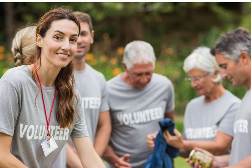Happy volunteer looking at donation box