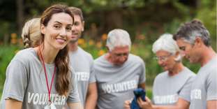 Happy volunteer looking at donation box