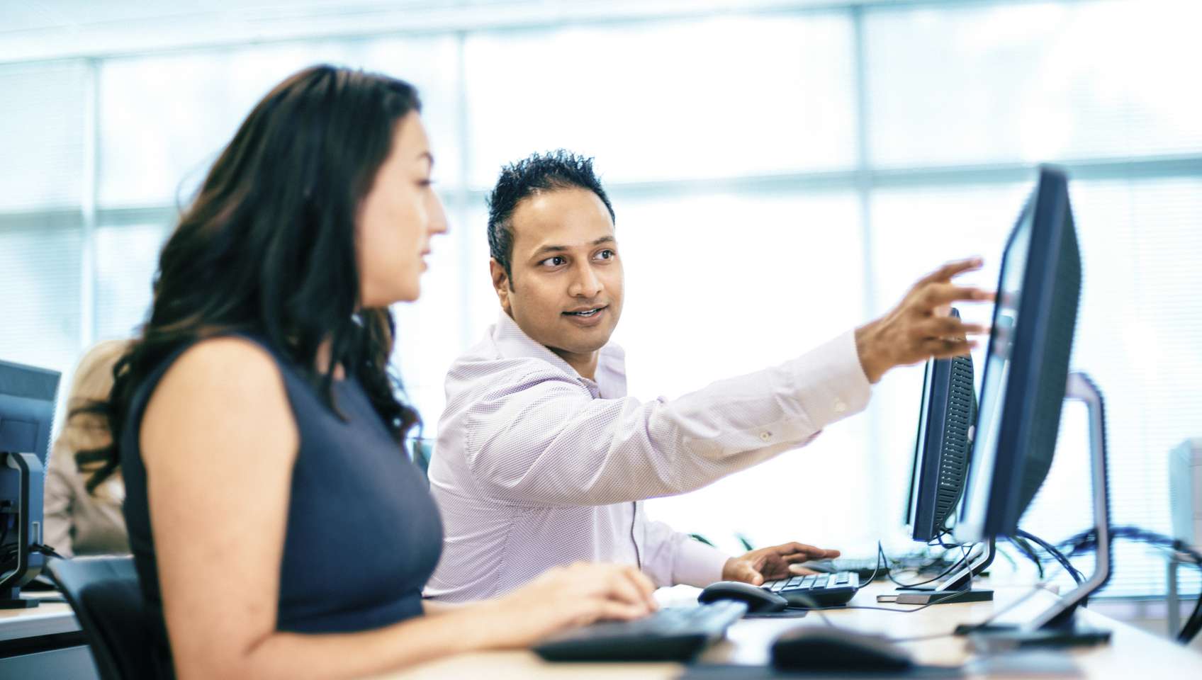 Two workers looking at screen iStock_30762560_MEDIUM