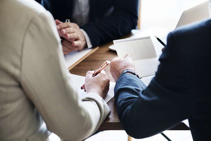 Businessmen and women working through business accounts
